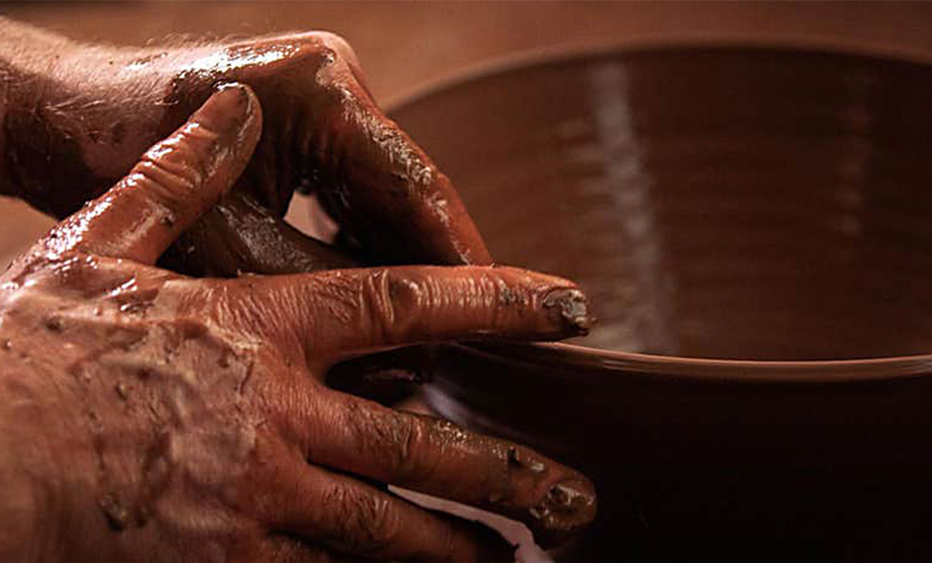 Rossa Pottery Working At Wheel